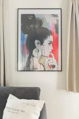 a painting hanging on a wall above a couch at The Athens Version Luxury Suites in Athens