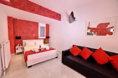 a living room with a couch and a bed at Central Athens Studios in Athens