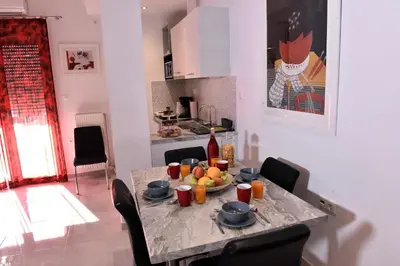 a table with a bowl of fruit on it in a kitchen at Central Athens Studios in Athens