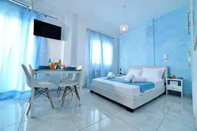 a blue bedroom with a bed and a desk at Central Athens Studios in Athens