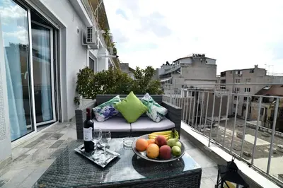 a bowl of fruit on a table on a balcony at Central Athens Studios in Athens