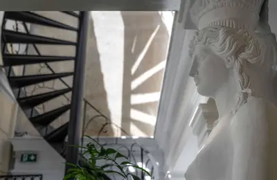 a statue of a bust of a woman on a staircase at Noble Suites in Athens
