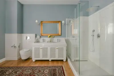 a bathroom with a sink and a toilet and a mirror at Noble Suites in Athens