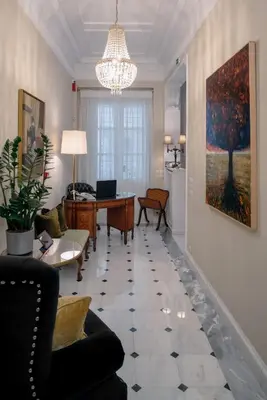 a living room with a couch and a table at Noble Suites in Athens