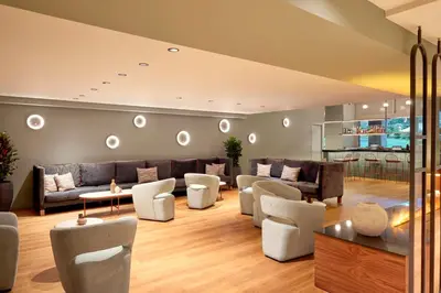 a living room with couches and chairs at Zeus Essence Wyndham Athens Residence in Athens