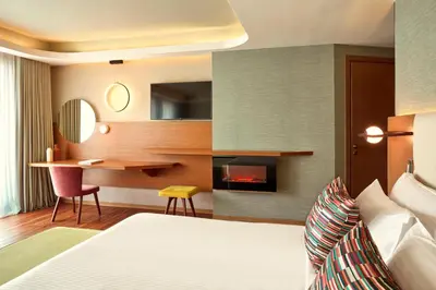 a hotel room with a bed and a desk at Zeus Essence Wyndham Athens Residence in Athens