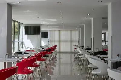 a restaurant with red and white tables and chairs at Breeze Boutique Athens by Prima Hotels in Athens