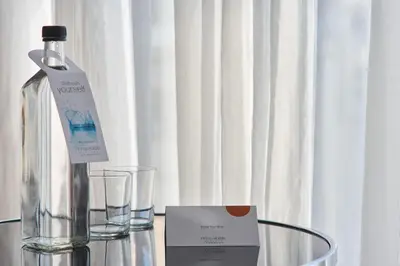 a bottle of water and glasses on a table at Breeze Boutique Athens by Prima Hotels in Athens