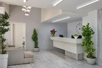 a lobby with potted plants and a reception desk at Breeze Boutique Athens by Prima Hotels in Athens