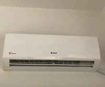 a white appliance sitting on top of a wall at Raise cosy apartment in Athens