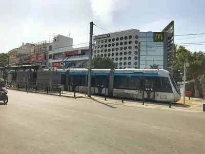 a train is parked on the side of a street at Raise cosy apartment in Athens