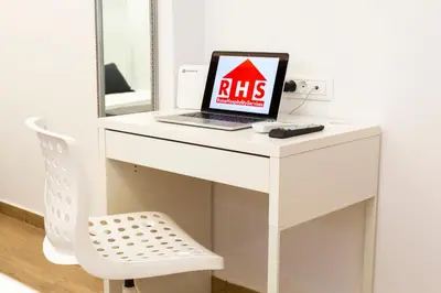 a laptop computer sitting on a white desk with a mirror at Raise cosy apartment in Athens