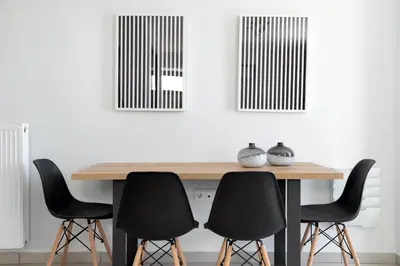 a dining room table with four black chairs at Supreme D1 Penthouse 131m² in Syntagma in Athens
