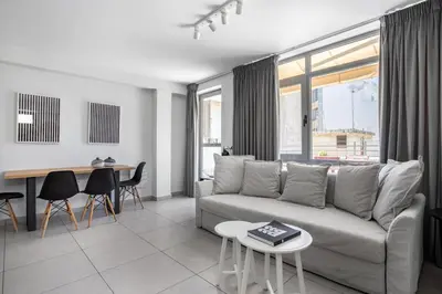 a living room with a couch and a table at Supreme D1 Penthouse 131m² in Syntagma in Athens