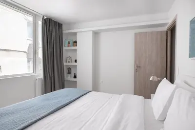 a bedroom with a white bed and a window at Supreme D1 Penthouse 131m² in Syntagma in Athens