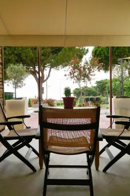 a group of chairs and a table in a patio at me gusta suite by the sea in Anavissos