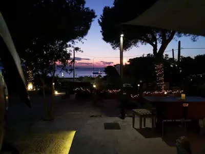 a view of a sunset with a street light at me gusta suite by the sea in Anavissos