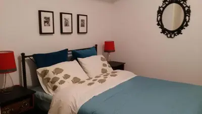 a bedroom with a bed and a mirror on the wall at Rooms in Central Athens in Athens