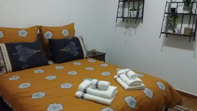 a bedroom with a bed with towels on it at Rooms in Central Athens in Athens
