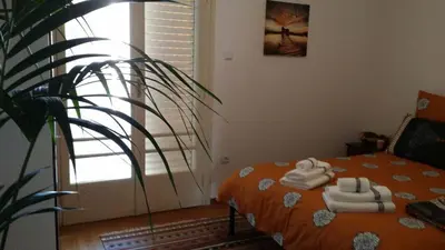 a bedroom with a bed with towels on it at Rooms in Central Athens in Athens