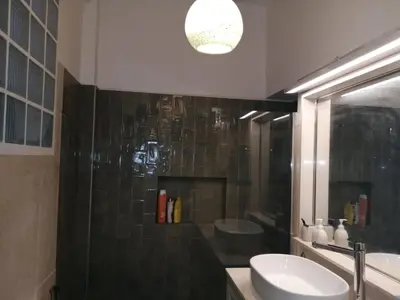 a bathroom with a sink and a mirror at Rooms in Central Athens in Athens