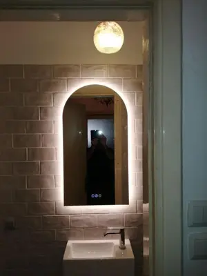 a person taking a picture of a bathroom mirror at Rooms in Central Athens in Athens