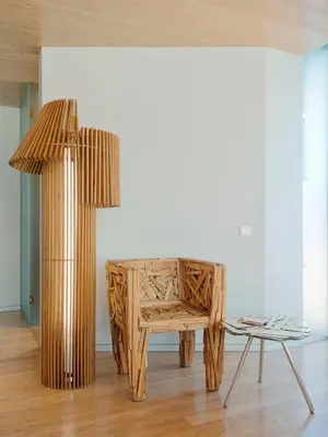 a table and a chair in a room with a lamp at New Hotel in Athens