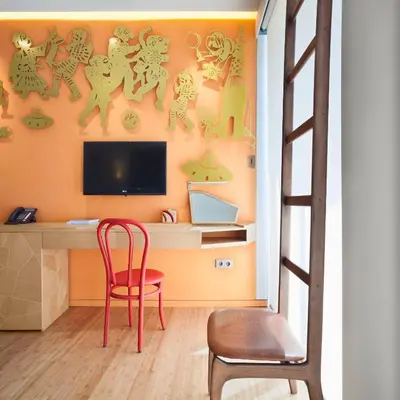 a room with a desk with a television and a chair at New Hotel in Athens
