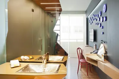 a bathroom with two sinks and a mirror at New Hotel in Athens