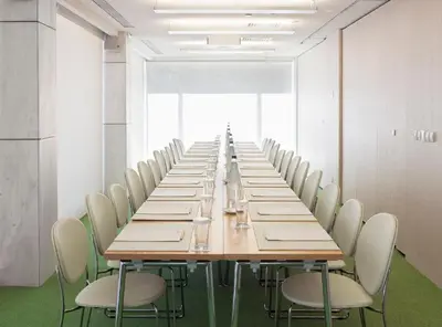 a long conference room with a long table and chairs at New Hotel in Athens