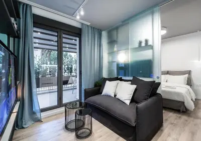a living room with a couch and a bed at Syntagma Elysan Urban Stays in Athens