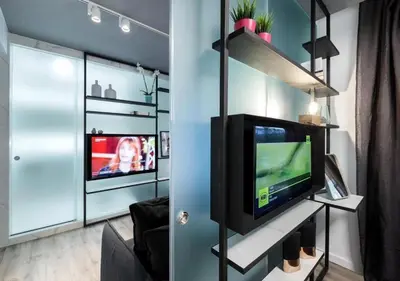 a living room with a television on a shelf at Syntagma Elysan Urban Stays in Athens
