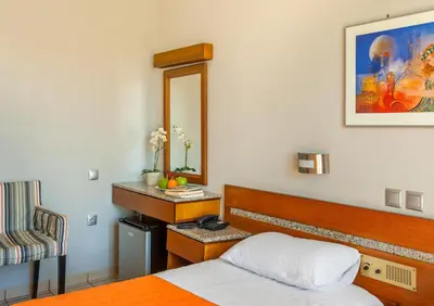 a hotel room with a bed and a mirror at Park Hotel in Athens