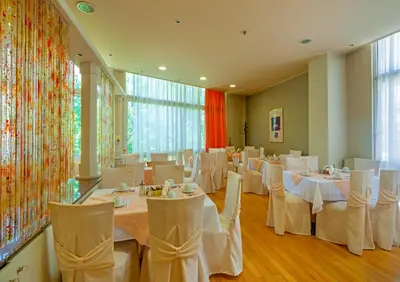 a banquet hall with white tables and chairs at Park Hotel in Athens