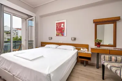 a bedroom with a large white bed and a window at Park Hotel in Athens