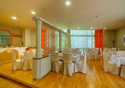 a banquet hall with white tables and white chairs at Park Hotel in Athens