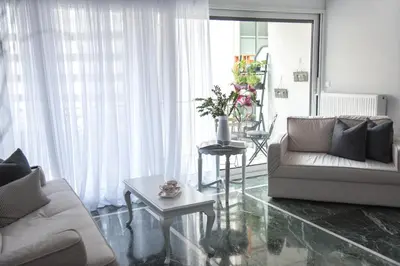 a living room with a couch and a table at Living near Acropolis by Sylvia Staikou 2nd & 3d floor in Athens