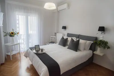 a bedroom with a large bed with a table on it at Living near Acropolis by Sylvia Staikou 2nd & 3d floor in Athens