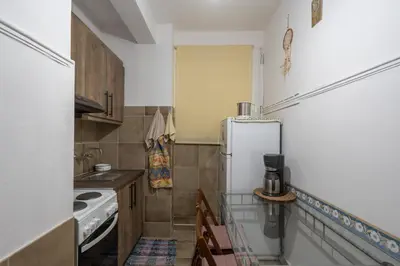 a small kitchen with a refrigerator and a stove at The Sweetest Acropolis Flat in Athens