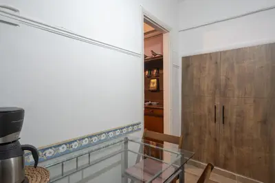a dining room with a glass table and a wooden door at The Sweetest Acropolis Flat in Athens