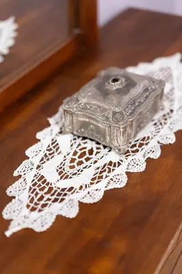 a glass box sitting on top of a white doily at The Sweetest Acropolis Flat in Athens