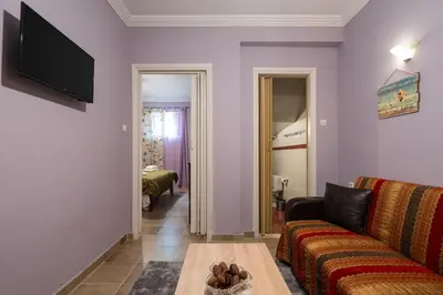 a living room with a couch and a table at The Sweetest Acropolis Flat in Athens