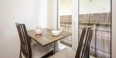 a small table and chairs in a room with a balcony at GK Mex in Athens