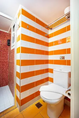 an orange and white bathroom with a toilet and a shower at GK Mex in Athens