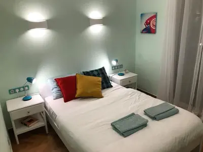 a bedroom with a bed with two pillows on it at Spacious & Sunny Kolonaki Apt 5 mins metro/ACx3/1.5 BT in Athens