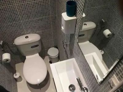 a small bathroom with a toilet and a sink at Spacious & Sunny Kolonaki Apt 5 mins metro/ACx3/1.5 BT in Athens