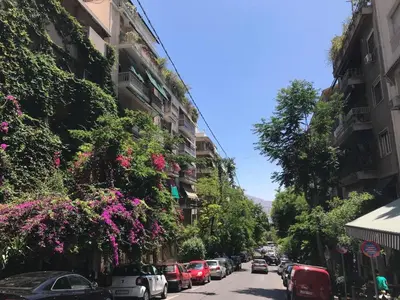 a street with cars parked on the sides of buildings at Spacious & Sunny Kolonaki Apt 5 mins metro/ACx3/1.5 BT in Athens