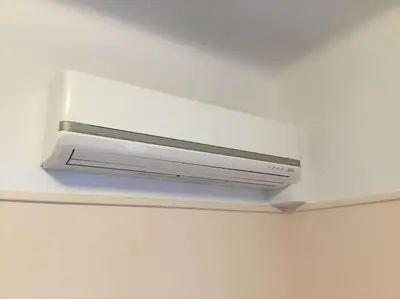 a white air conditioner on the ceiling of a room at Spacious & Sunny Kolonaki Apt 5 mins metro/ACx3/1.5 BT in Athens