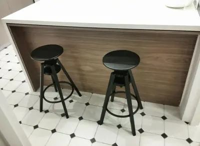 two black stools sitting under a counter in a kitchen at Central new Kolonaki apartment in Athens