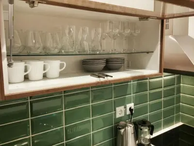a kitchen shelf with glasses and dishes on it at Central new Kolonaki apartment in Athens